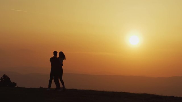 Couple dancing at sunset