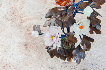 Vintage glass flowers on concrete background.