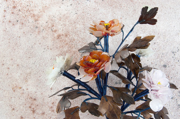 Vintage glass flowers on concrete background.