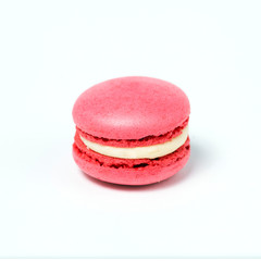 Sweet pink macaroon isolated on white background.