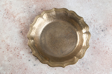 Vintage brass plate on concrete background.