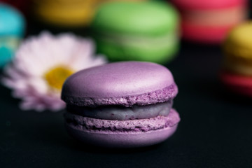 Macaroons on black background.