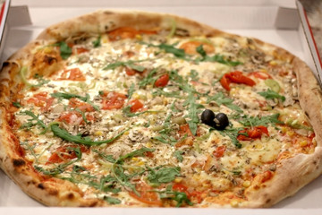 Delivered vegetarian pizza in a box. Selective focus.