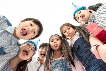 Group of Smiling Asian Kids Schoolchildren Embracing with Friends at Playground and Smiling to Camera