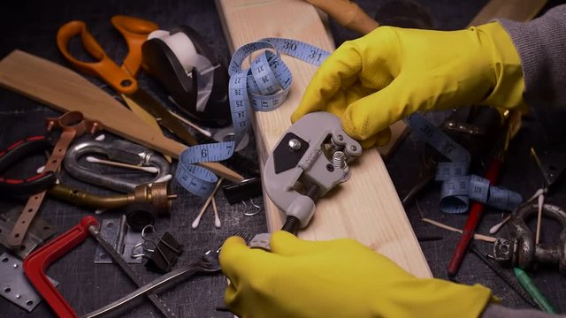 THE WRONG TOOL FOR THE JOB.  #7 IN A SERIES.  ECU SLIDER SHOT OF SOMEONE TRYING TO TIGHTEN A BOLT WITH A PIPE CUTTER.  IN 4K.