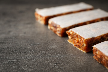 Tasty protein bars on grey table. Space for text