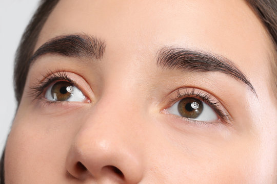 Young woman with beautiful natural eyelashes, closeup view