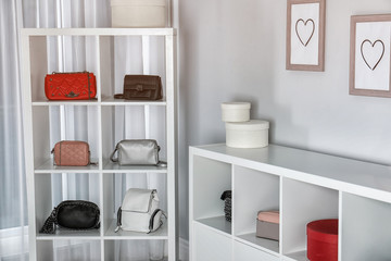 Fototapeta na wymiar Wardrobe shelves with different stylish bags indoors. Idea for interior design