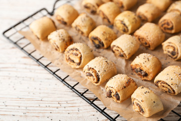 Tasty sweet cookies with poppy seeds on wooden table