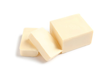 Cut block of fresh butter on white background
