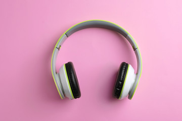 Wireless headphones on color background, top view