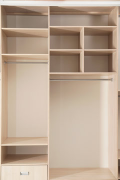 Empty wooden wardrobe with shelves as background