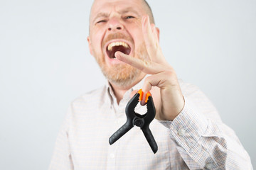 Industrial clamp pinched the finger of a man