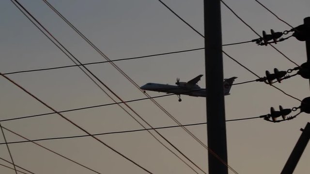 The plane can be seen through the mess of cables above the streets of Dhaka