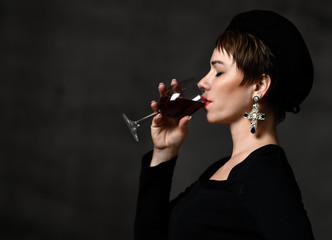 Business short hair woman drink red wine from glass