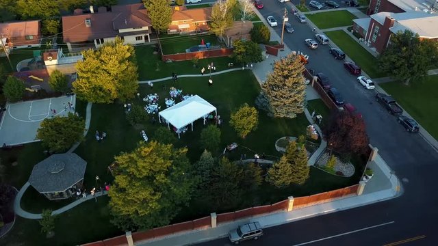 Bird's Eye View Aerial Shot Of A Backyard Outdoor Wedding Reception In A Suburban Neighborhood On A Bright Warm Summer Day.