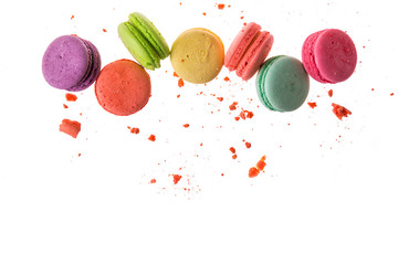 Flat lay, top view. French macaroons isolated on white background. Cookies falls mixed with crumbs....
