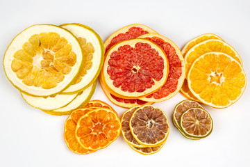 Dried slices of various citrus fruits on white background