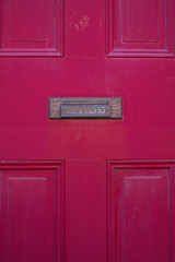 Brass letter slot on a restored red door in center city philadelphia