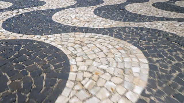 Walking on Copacabana Beach mosaic sidewalk, Rio de Janeiro, Brazil