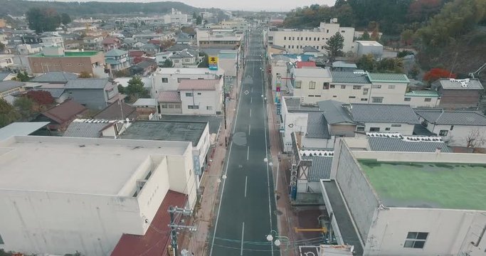 Aerial Drone Tracking Shot Following a Road Revealing the Ghost Town from the Fukushima Nuclear Powerplant Disaster.