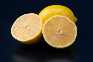 Cut citrus fruit of lemon on blue background