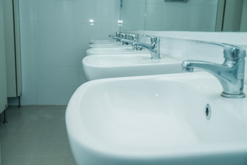 line of washbasin in public restroom