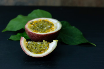 Fresh yellow passion fruit Cut half isolate on wood
