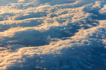 View from the airplane window over the clouds