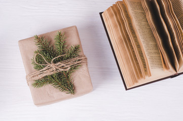 Christmas gift box and old books on a white wooden background. Christmas & New Year leisure  concept