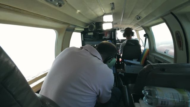 Male Scientist Inside Small Plane Working With Computer Equipment to Record Scientific Data. Flight Conducted as Part of a Research Mission in the Gothenburg Archipelago in Sweden.