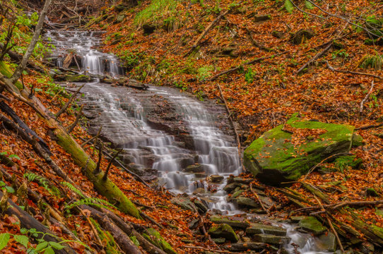 Waterfall on the stream in the forest. Otryt. Bieszczady Mountains.