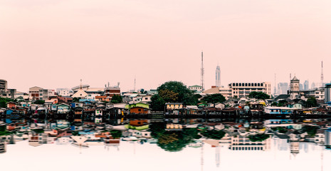 Urban scene landscape of Chao Phraya riverside with beautiful reflection : Bangkok , Thiland