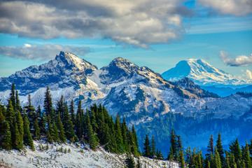 Sunset falls on two of the peaks of the Tatoosh Mountain Range (left) inside Mt. Rainier National Park. Mt. Adams, a dormant volcano, can be seen in distance (right). 