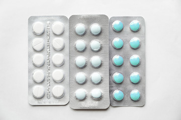 three blisters with multi-colored pills