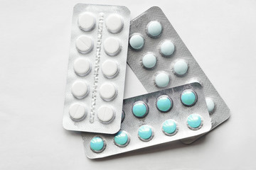 three blisters with multi-colored pills