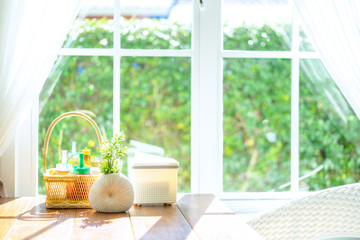 Dining table with morning sunlight and background of white window.