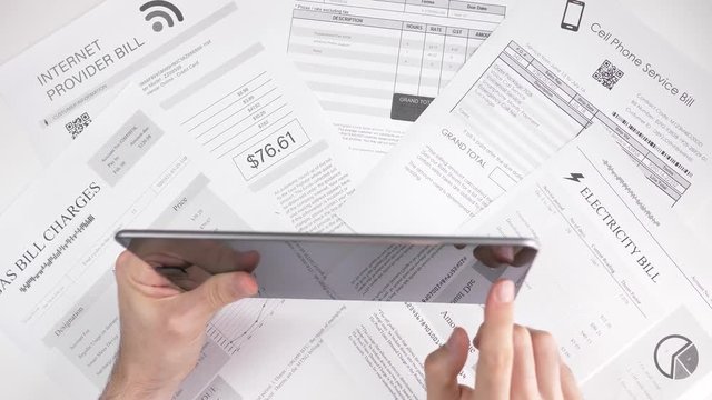 Paying bills using a tablet computer. Online utility bills payment concept.