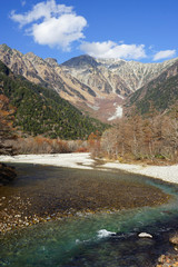 Naklejka na ściany i meble Beautiful crystal clear water river landscape with mountain background in Japan Alps Kamikochi