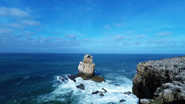 Atlantic ocean waves crushing into cliff rocks in Nau dos Corvos Rock in Peniche, Portugal