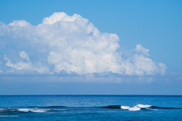 Waves of the Atlantic Ocean big beautiful clouds in the blue sky