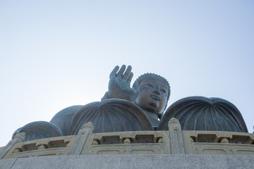Closeup horizontal photo of Tian Tan Buddha, Lantau Island, Hong Kong. copy space in sky above buddha.