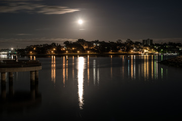 Full moon over houses and water