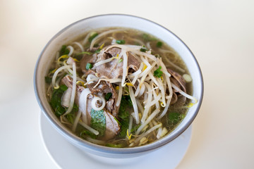 Vietnamese beef pho noodle soup on the white table