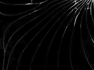 Cracked glass texture on black background. Isolated realistic cracked glass effect.