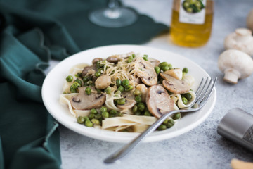 Pasta with Green Peas and Mushrooms on a White Background