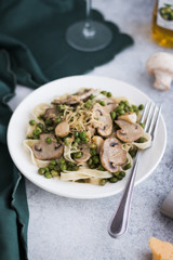 Pasta with Green Peas and Mushrooms on a White Background