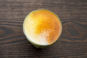 Gold-coloured turmeric latte in the cup