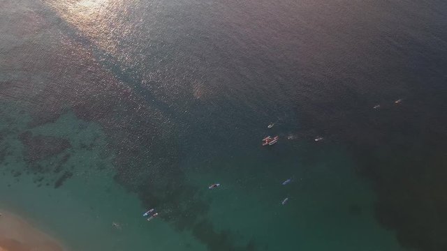 I used my Mavic Pro to capture this beautiful shot of surfers surfing back to shore. I downsized the 4K footage to 1080p to obtain sharp and lighter image. 
This was shot in Sunset Beach on Oahu.