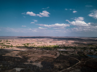 Drone photography of a valley , semi-arid of Ceara, blue sky, clouds , pastel tons, Brazil.